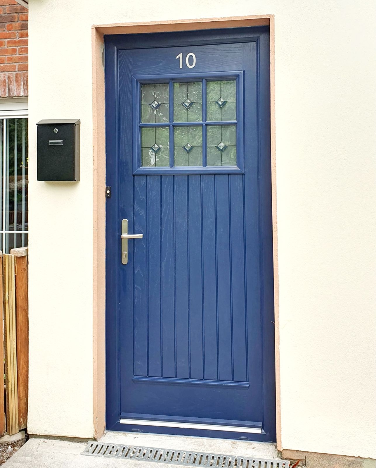 Blue cottage-style door with leaded glass