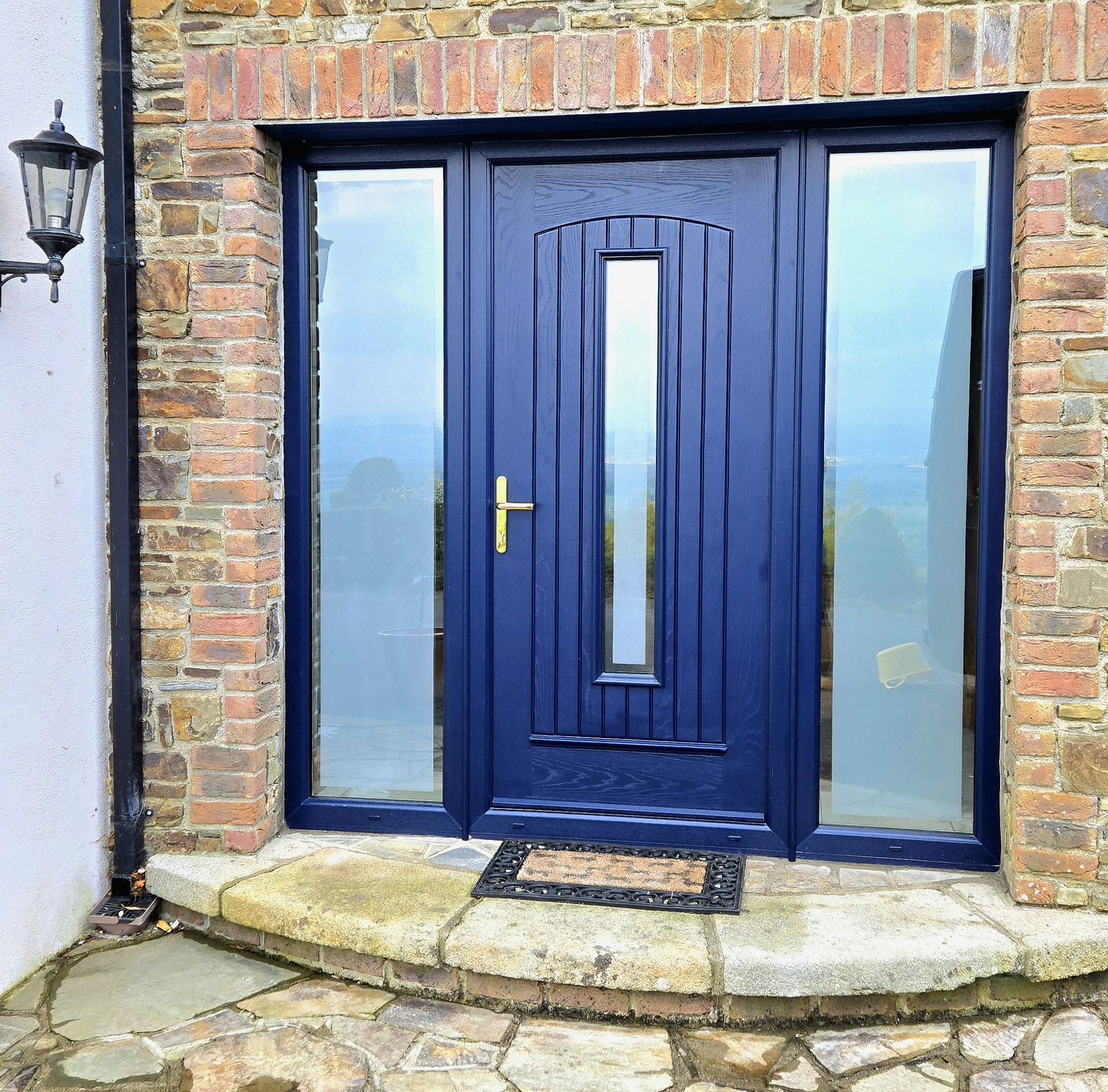 Blue front door with two glazed side panels
