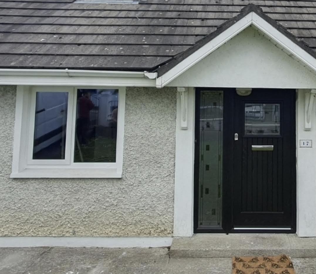 Black front door on a bungalow porch