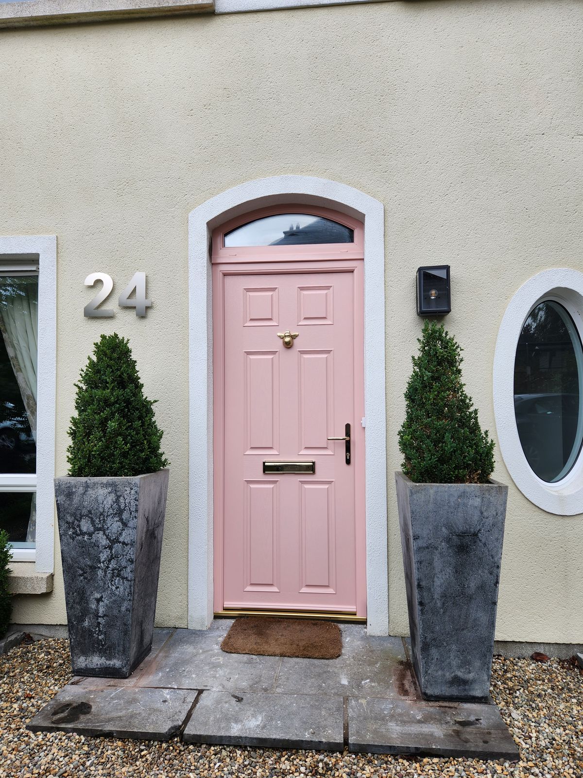 Pink front door with arched toplight