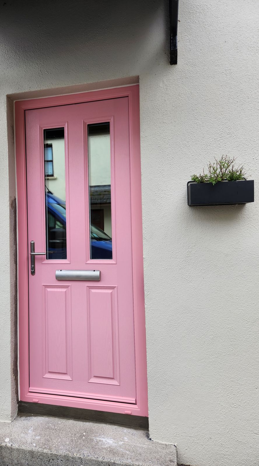 Pink front door with two glass panels