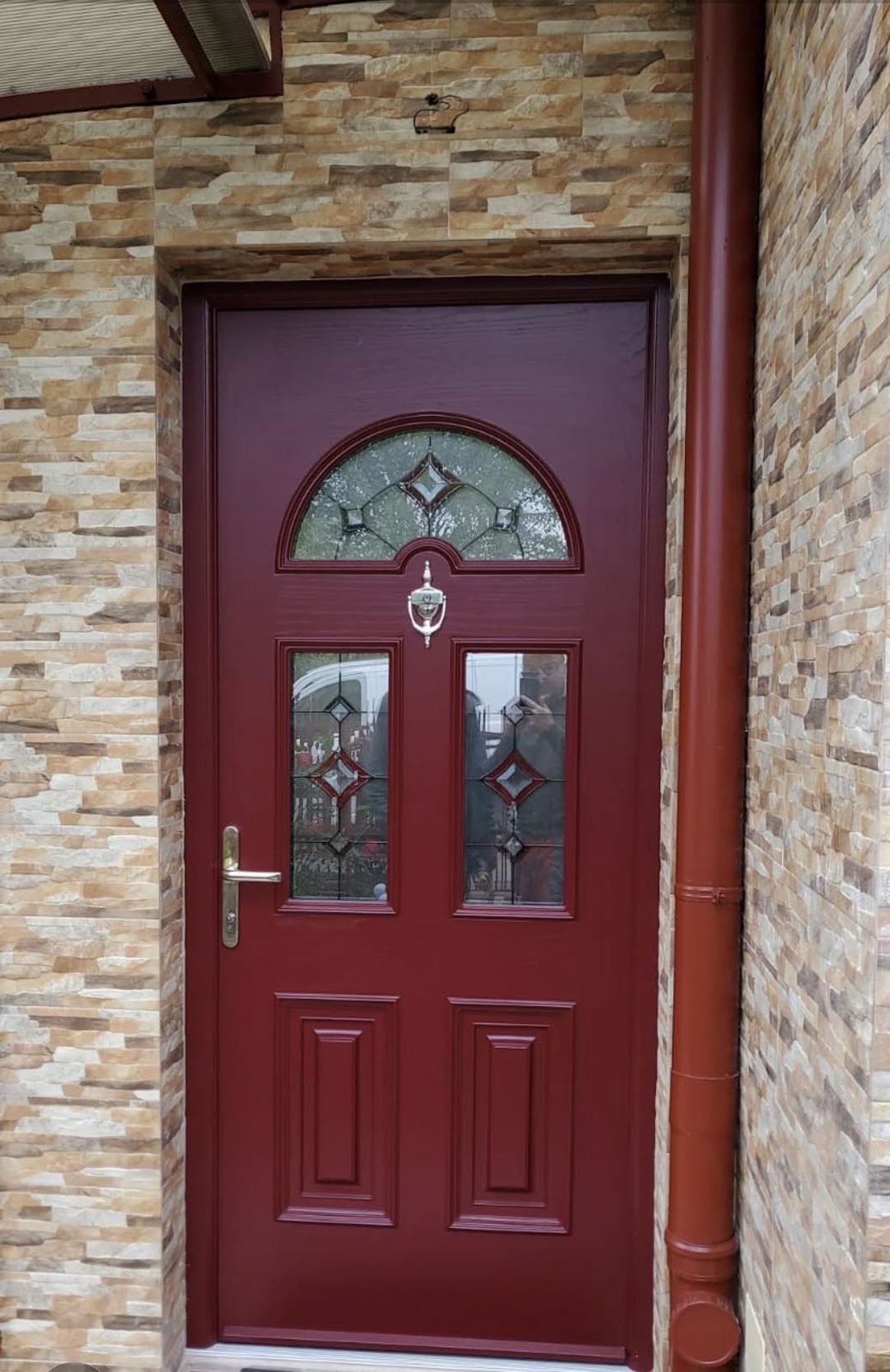 Red front door with arched glass