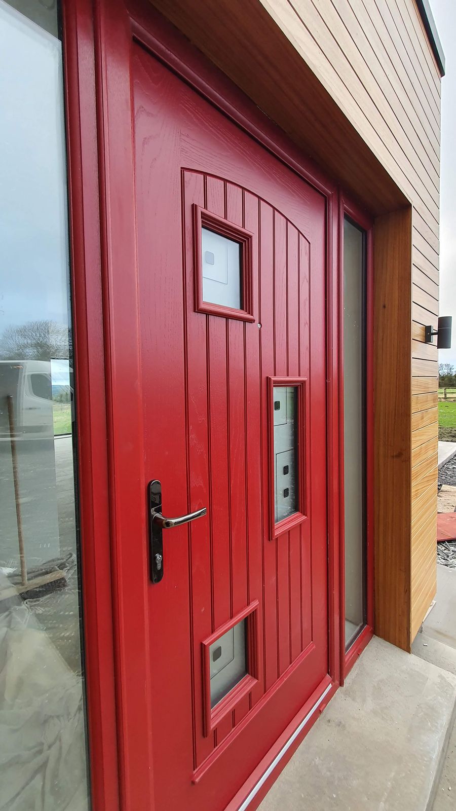 Red front door with glazed side panel