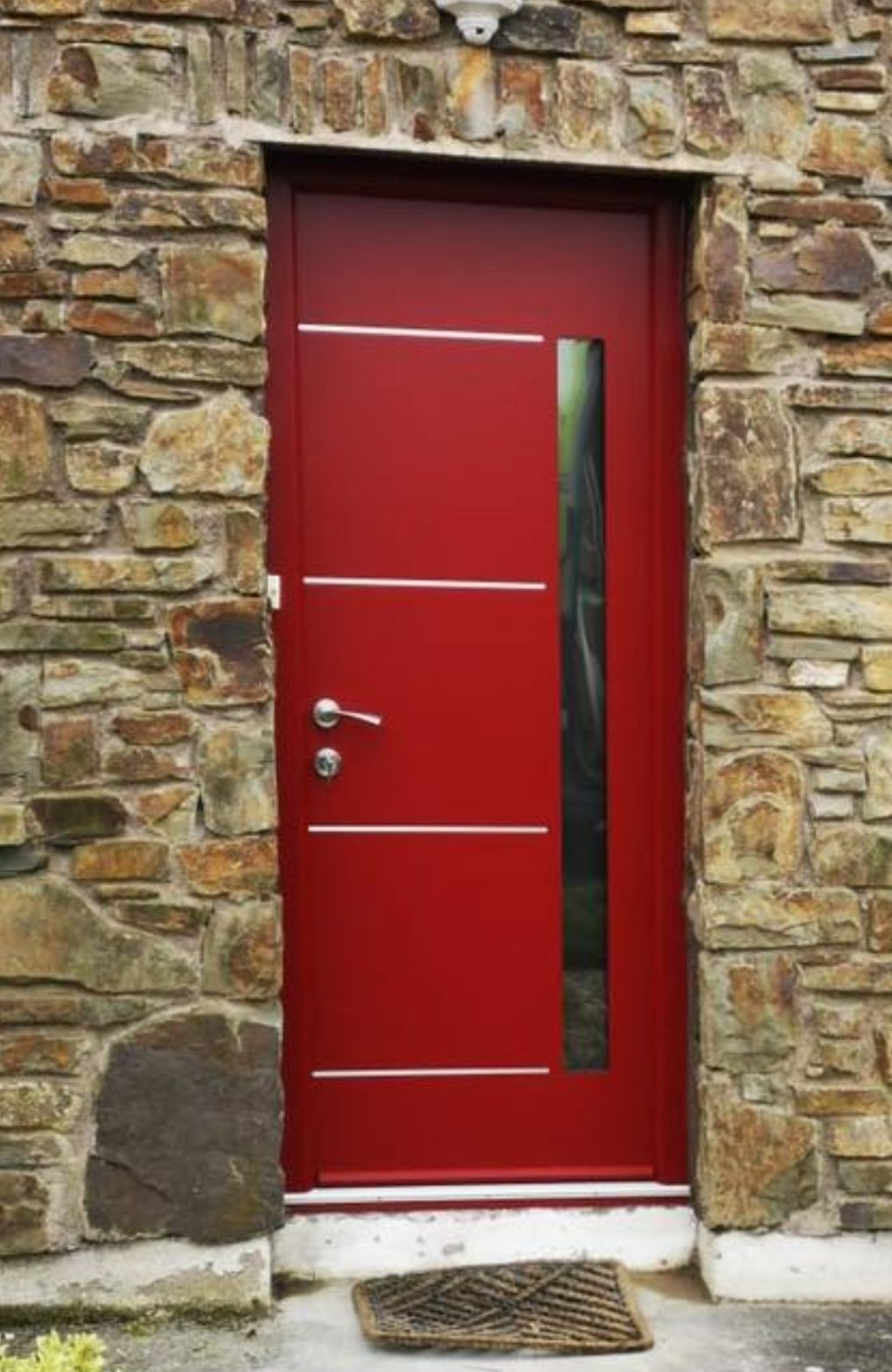 Red front door in a stone wall