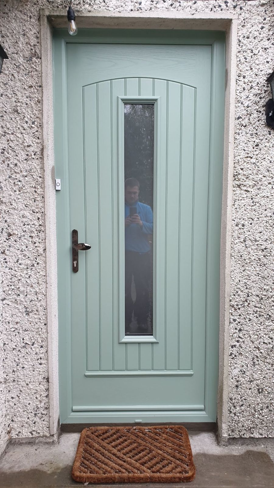 Sage green door with tall glass panel