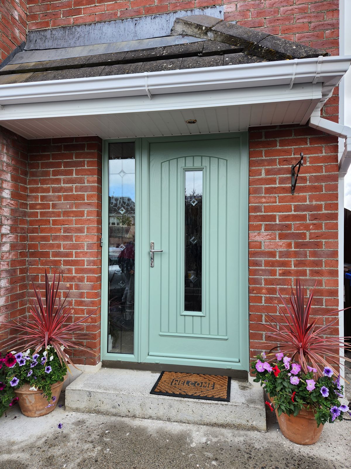 Sage green front door with side panel